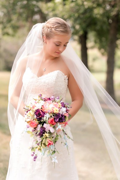 Bismarck bride in cathedral veil and summer colorful bouquet. Photo taken by Photography by Justine Bismarck Wedding Photographer